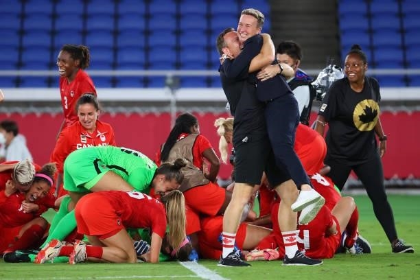 Team Canada Head Coach Beverly Priestman celebrates after defeating Team Sweden in a penalty kick shoot-out to win the women's football gold medal...