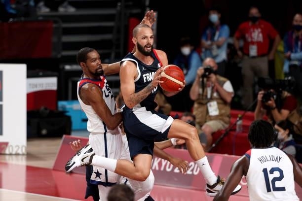 Evan Fournier of Team France looks to pass the ball as Kevin Durant of Team United States defends during the first half of a Men's Basketball Finals...