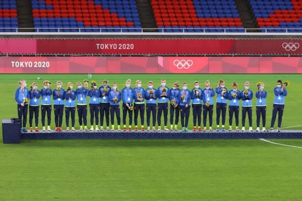 Team Sweden stands with their silver medals after being defeated by Team Canada during the women's football gold medal match between Canada and...