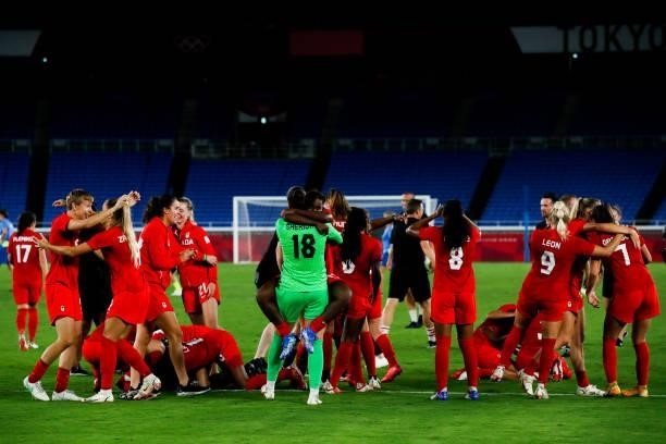 Players of Canada celebrate the victory after the penalty shot out of the Olympic women's football gold medal match between Sweden and Canada at...