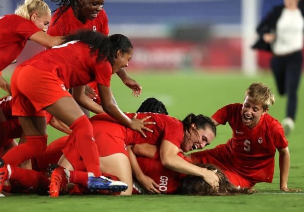 Players of Team Canada celebrate following their team's victory in the penalty shoot out in the Women's Gold Medal Match between Canada and Sweden at...