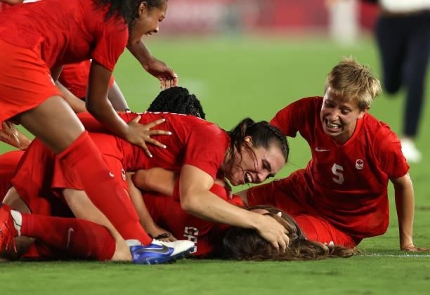 Players of Team Canada celebrate following their team's victory in the penalty shoot out in the Women's Gold Medal Match between Canada and Sweden at...