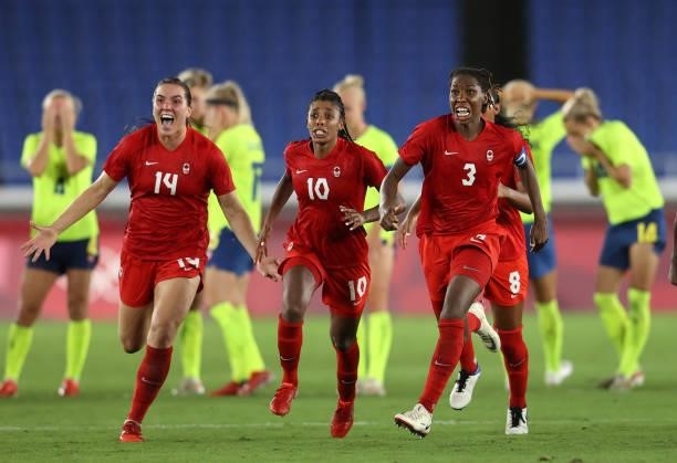 Vanessa Gilles, Ashley Lawrence and Kadeisha Buchanan of Team Canada celebrate following their team's victory in the penalty shoot out in the Women's...