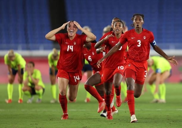 Vanessa Gilles, Ashley Lawrence and Kadeisha Buchanan of Team Canada celebrate following their team's victory in the penalty shoot out in the Women's...