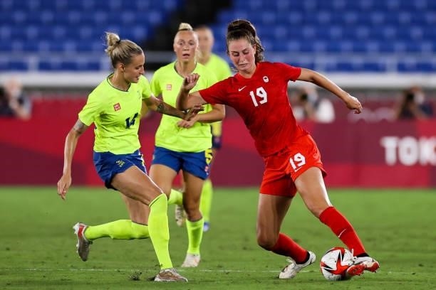 Jordyn Huitema of Team Canada competes for the ball with Nathalie Bjorn of Team Sweden during the Olympic women's football gold medal match between...