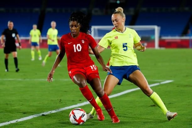 Ashley Lawrence of Team Canada competes for the ball with Hanna Bennison of Team Sweden during the Olympic women's football gold medal match between...