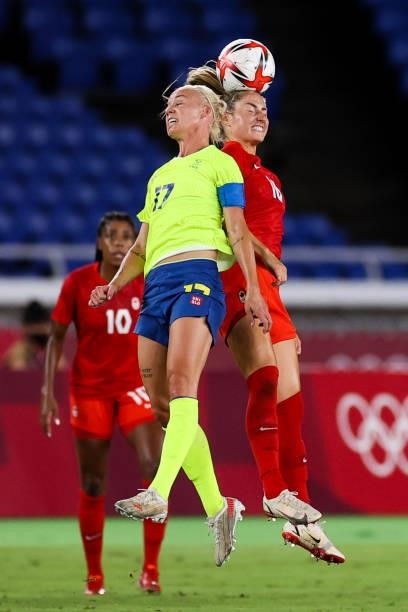 Caroline Seger of Team Sweden competes for the ball with Janine Beckie of Team Canada during the Olympic women's football gold medal match between...