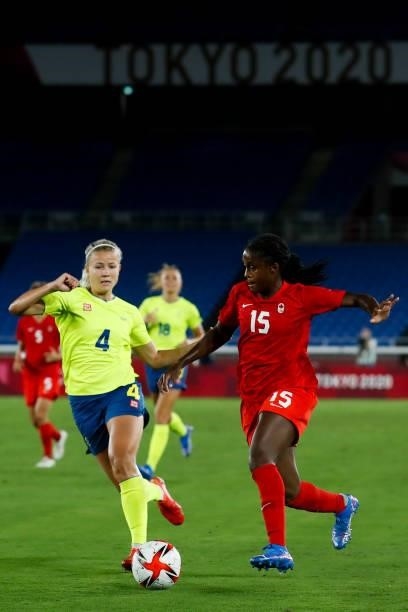 Nichelle Prince of Team Canada competes for the ball with Hanna Glas of Team Sweden during the Olympic women's football gold medal match between...