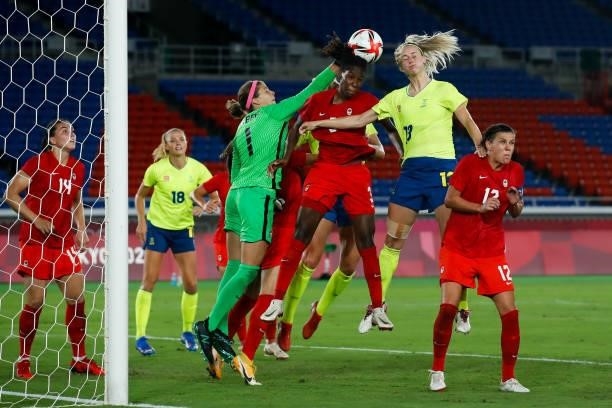 Kadeisha Buchanan and Stephanie Labbe of Team Canada competes for the ball with Amanda Ilestedt of Team Sweden during the Olympic women's football...