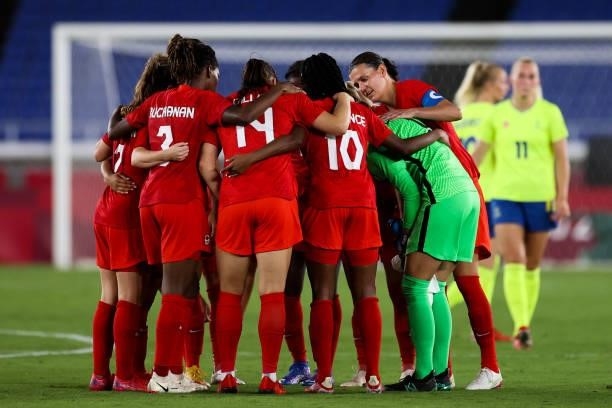 Players of Team Canada encourage each other during the Olympic women's football gold medal match between Sweden and Canada at International Stadium...