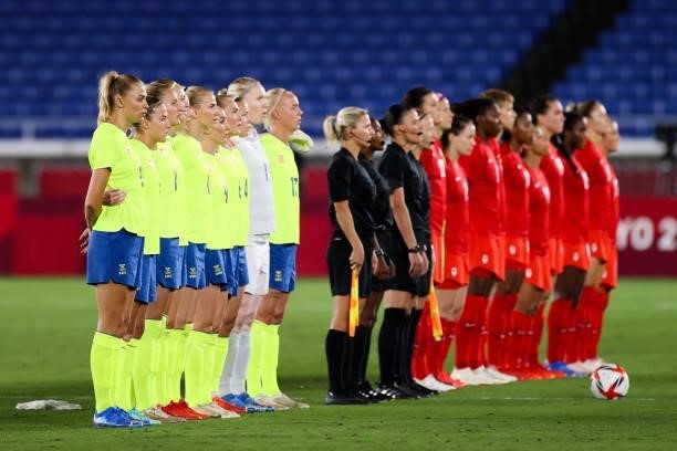 Both team players line up during the Olympic women's football gold medal match between Sweden and Canada at International Stadium Yokohama on August...