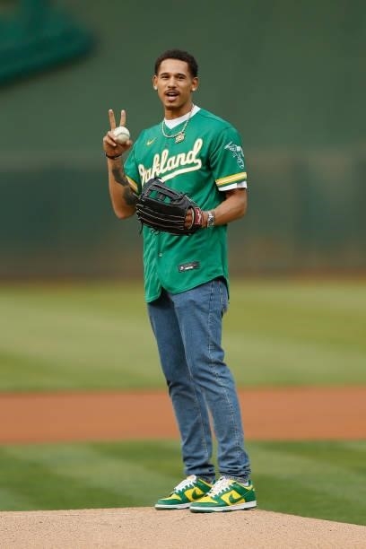 Player Juan Toscano-Anderson of the Golden State Warriors asks to throw a second attempt for the ceremonial first pitch before the game between the...