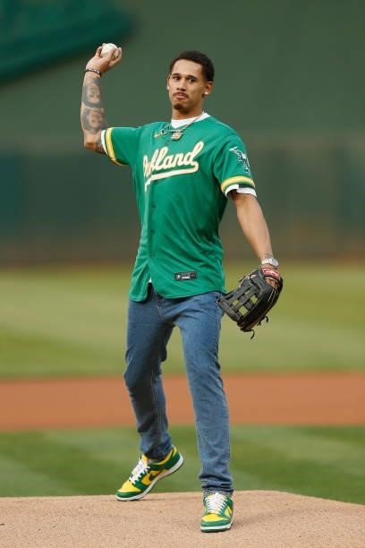 Player Juan Toscano-Anderson of the Golden State Warriors throws out a second attempt at the ceremonial first pitch before the game between the...
