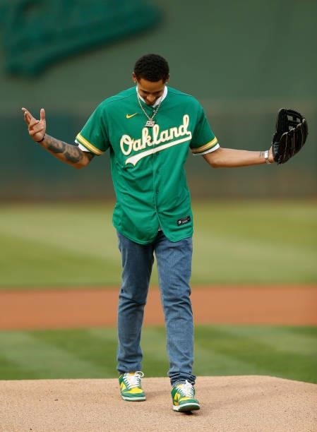 Player Juan Toscano-Anderson of the Golden State Warriors reacts after throwing out a second attempt at the ceremonial first pitch before the game...