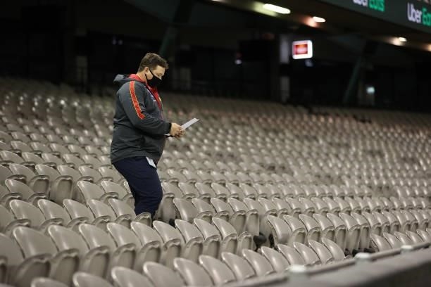 Suns coach, Stuart Dew heads onto the ground at he break during the round 21 AFL match between Carlton Blues and Gold Coast Suns at Marvel Stadium on...