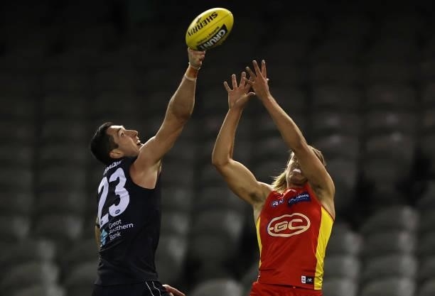 Jacob Weitering of the Blues and Jeremy Sharp of the Suns compete for the ball during the round 21 AFL match between Carlton Blues and Gold Coast...