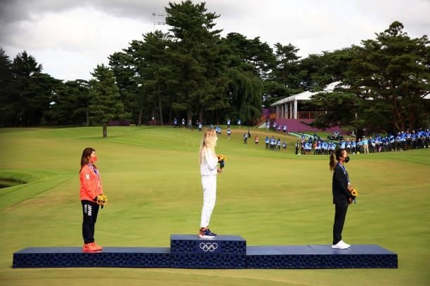 Silver medalist Mone Inami of Team Japan, gold medalist Nelly Korda of Team United States and bronze medalist Lydia Ko of Team New Zealand stand on...