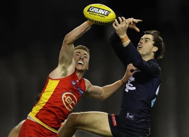 Jacob Townsend of the Suns and Lachie Plowman of the Blues compete for the ball during the round 21 AFL match between Carlton Blues and Gold Coast...