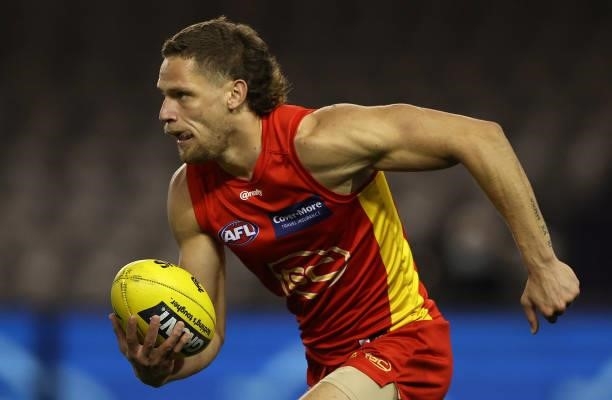 Jy Faffar of the Suns runs with the ball during the round 21 AFL match between Carlton Blues and Gold Coast Suns at Marvel Stadium on August 07, 2021...