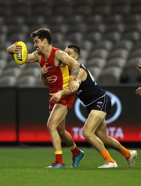 Alex Sexton of the Suns is challenged by Nic Newman of the Blues during the round 21 AFL match between Carlton Blues and Gold Coast Suns at Marvel...