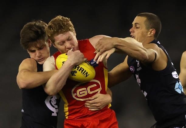 Matt Rowell of the Suns is challenged during the round 21 AFL match between Carlton Blues and Gold Coast Suns at Marvel Stadium on August 07, 2021 in...