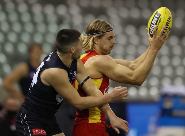 Jeremy Sharp of the Suns marks over Nic Newman of the Blues during the round 21 AFL match between Carlton Blues and Gold Coast Suns at Marvel Stadium...