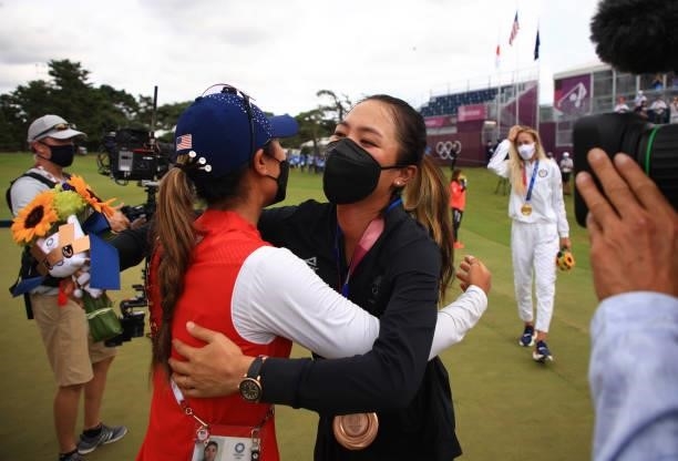 Lydia Ko of Team New Zealand is congratulated by Danielle Kang of Team United States on her bronze-medal win after the victory ceremony and final...