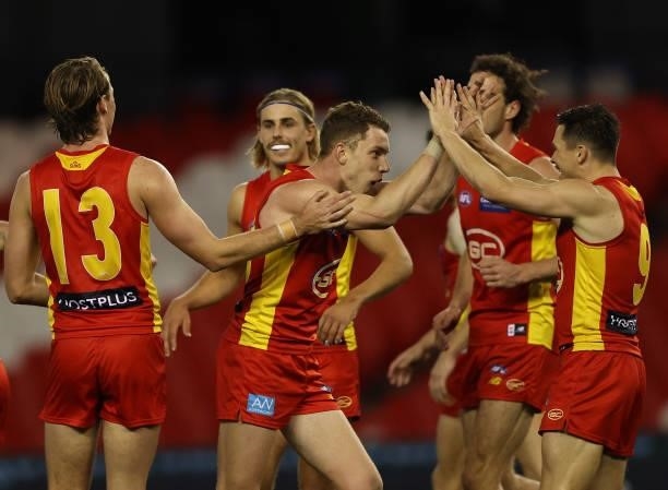 Josh Corbett of the Suns celebrates after scoring a goal during the round 21 AFL match between Carlton Blues and Gold Coast Suns at Marvel Stadium on...