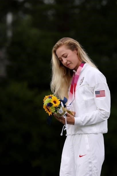 Nelly Korda of Team United States admires her gold medal at the victory ceremony after the final round of the Women's Individual Stroke Play on day...