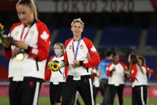 Gold medalist Quinn of Team Canada reacts with their gold medal after becoming the first openly transgender athlete to win Olympic gold during the...