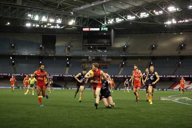 Matt Rowell of the Suns runs with the ball during the round 21 AFL match between Carlton Blues and Gold Coast Suns at Marvel Stadium on August 07,...