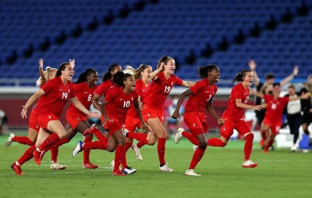 Team Canada celebrate after winning the gold medal after winning the penalty shoot out during the Gold Medal Match Women's Football match between...
