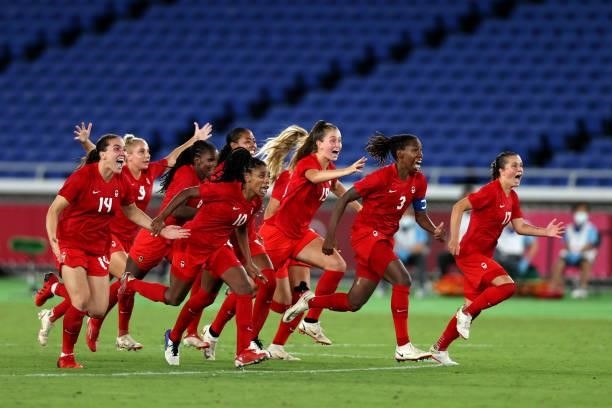 Team Canada celebrate after winning the gold medal after winning the penalty shoot out during the Gold Medal Match Women's Football match between...