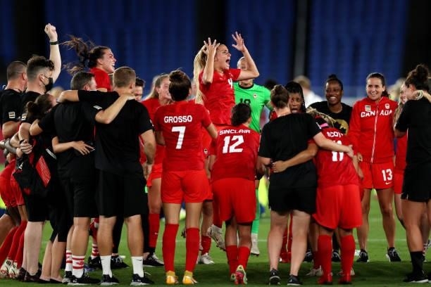 Shelina Zadorsky of Team Canada celebrates with her team in a huddle after her teams victory in the Gold Medal Match Women's Football match between...