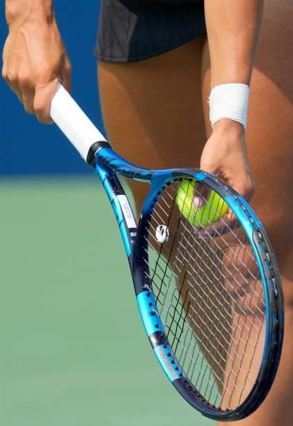 Detailed view of Yulia Putintseva of Kazakhstan using a Babolat tennis racket preparing to serve a Wilson tennis ball to Elise Mertens of Belgium...