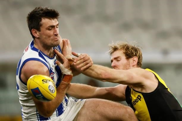 Tom Campbell of the Kangaroos and David Astbury of the Tigers contest the ball during the round 21 AFL match between Richmond Tigers and North...