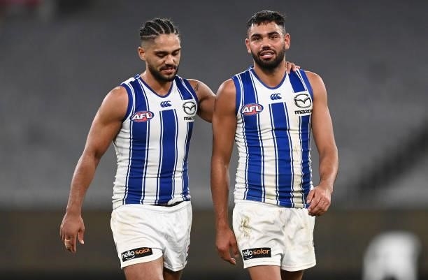Aaron Hall and Tarryn Thomas of the Kangaroos look dejected after losing the round 21 AFL match between Richmond Tigers and North Melbourne Kangaroos...