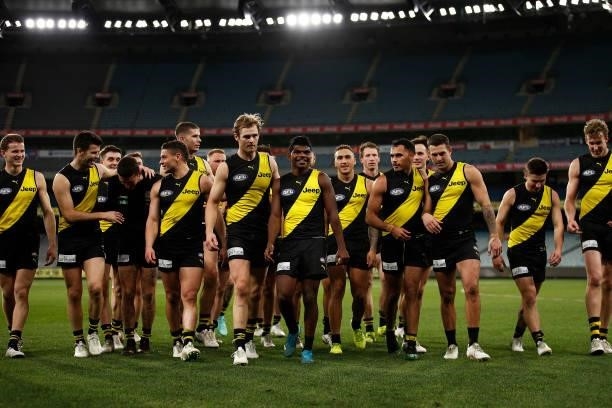 The Tigers celebrate victory after the round 21 AFL match between Richmond Tigers and North Melbourne Kangaroos at Melbourne Cricket Ground on August...