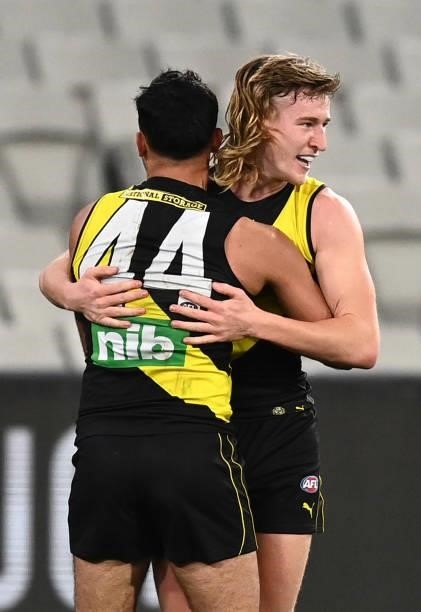 Hugo Ralphsmith of the Tigers is congratulated by Sydney Stack after kicking a goal during the round 21 AFL match between Richmond Tigers and North...