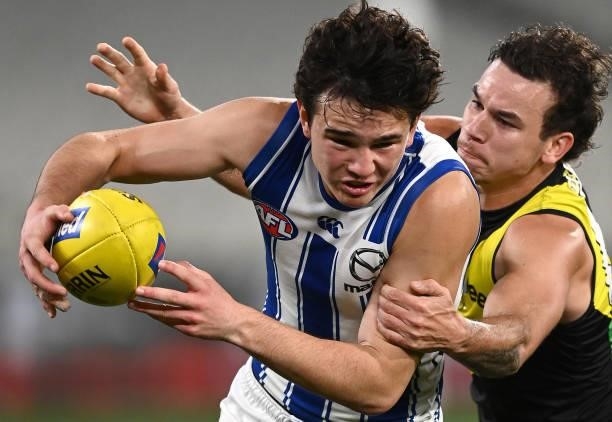 Eddie Ford of the Kangaroos is tackled by Daniel Rioli of the Tigers during the round 21 AFL match between Richmond Tigers and North Melbourne...