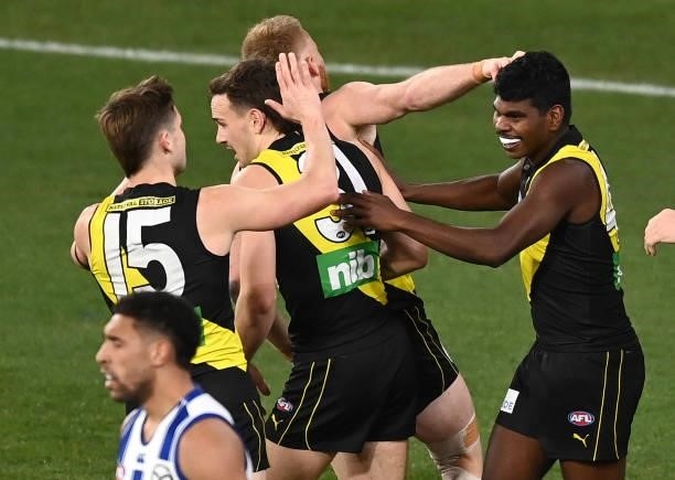 Maurice Rioli of the Tigers is congratulated by team mates after kicking a goal during the round 21 AFL match between Richmond Tigers and North...