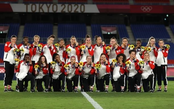 Team Canada celebrate winning the gold medal during the medal ceremony during the Gold Medal Match Women's Football match between Canada and Sweden...