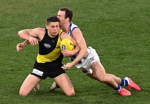 Dion Prestia of the Tigers is tackled by Jack Mahony of the Kangaroos during the round 21 AFL match between Richmond Tigers and North Melbourne...