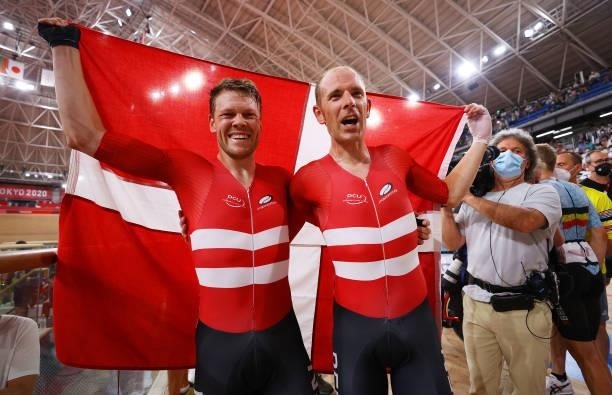 Lasse Norman Hansen of Team Denmark and Michael Morkov of Denmark celebrate winning the gold medals while holding the flag of they country during the...