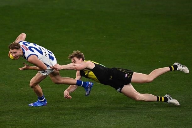 Ben McKay of the Kangaroos is tackled by Tom J. Lynch of the Tigers during the round 21 AFL match between Richmond Tigers and North Melbourne...