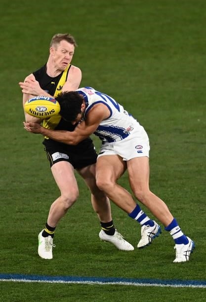 Jack Riewoldt of the Tigers is tackled by Robbie Tarrant of the Kangaroos during the round 21 AFL match between Richmond Tigers and North Melbourne...