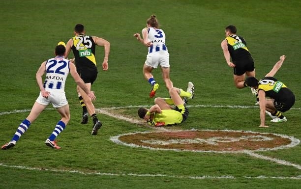 Umpire Hayden Gavine falls to the ground during the round 21 AFL match between Richmond Tigers and North Melbourne Kangaroos at Melbourne Cricket...