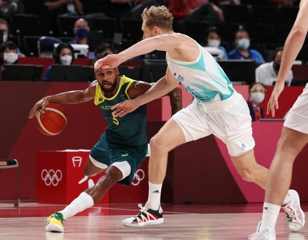 Patty Mills of Team Australia drives to the basket against Jaka Blazic of Team Slovenia during the first half of the Men's Basketball Bronze medal...