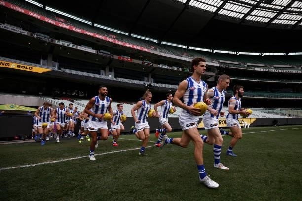 The Kangaroos run out during the round 21 AFL match between Richmond Tigers and North Melbourne Kangaroos at Melbourne Cricket Ground on August 07,...