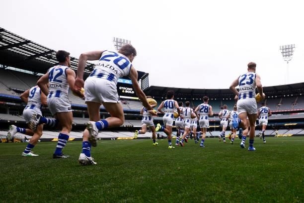 The Kangaroos run out during the round 21 AFL match between Richmond Tigers and North Melbourne Kangaroos at Melbourne Cricket Ground on August 07,...